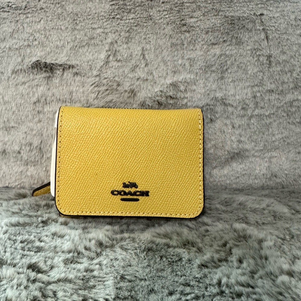 BRAND NEW NWT Coach wallet in the color Sunflower